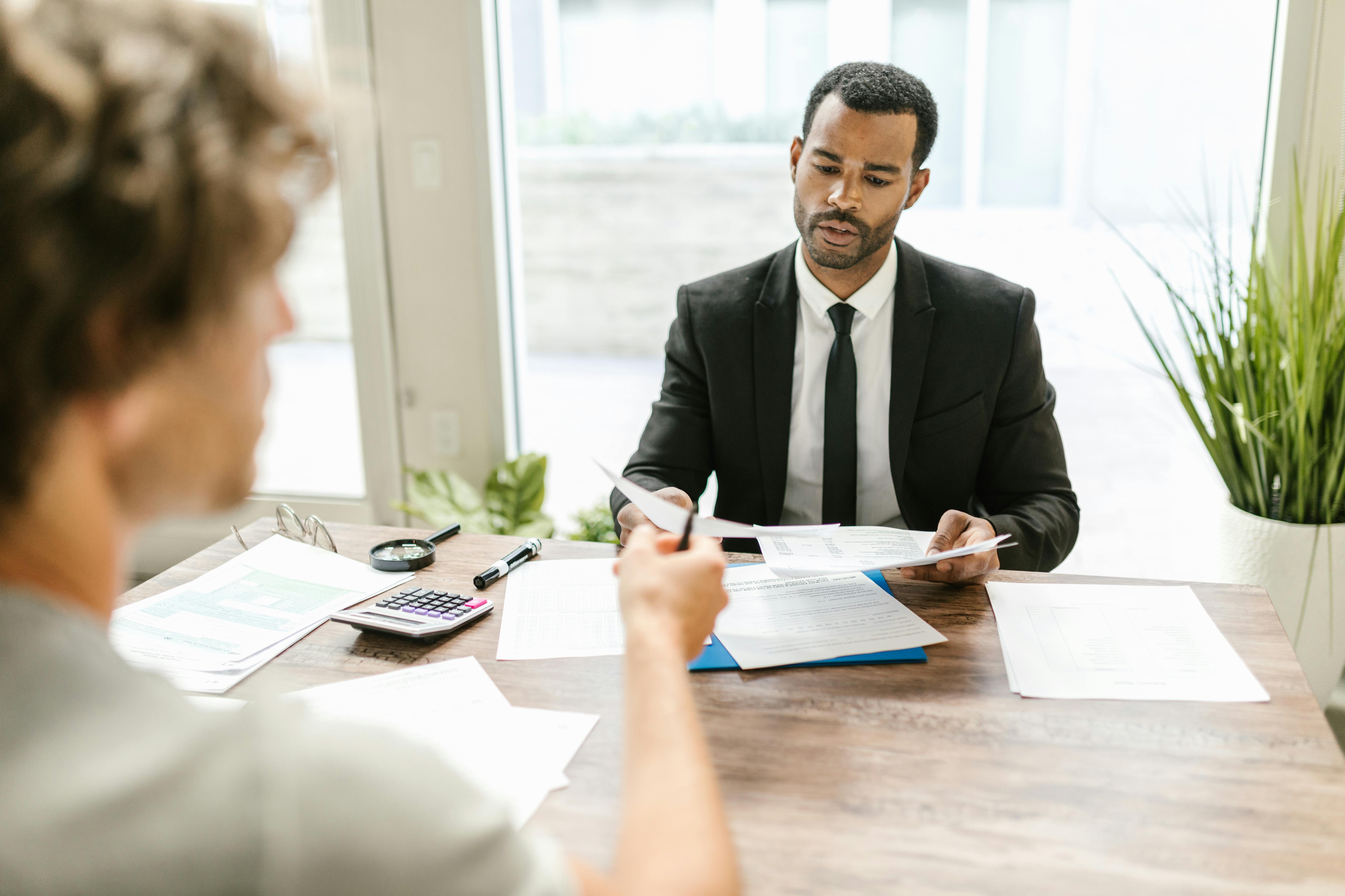 Manager reviewing compliance paperwork